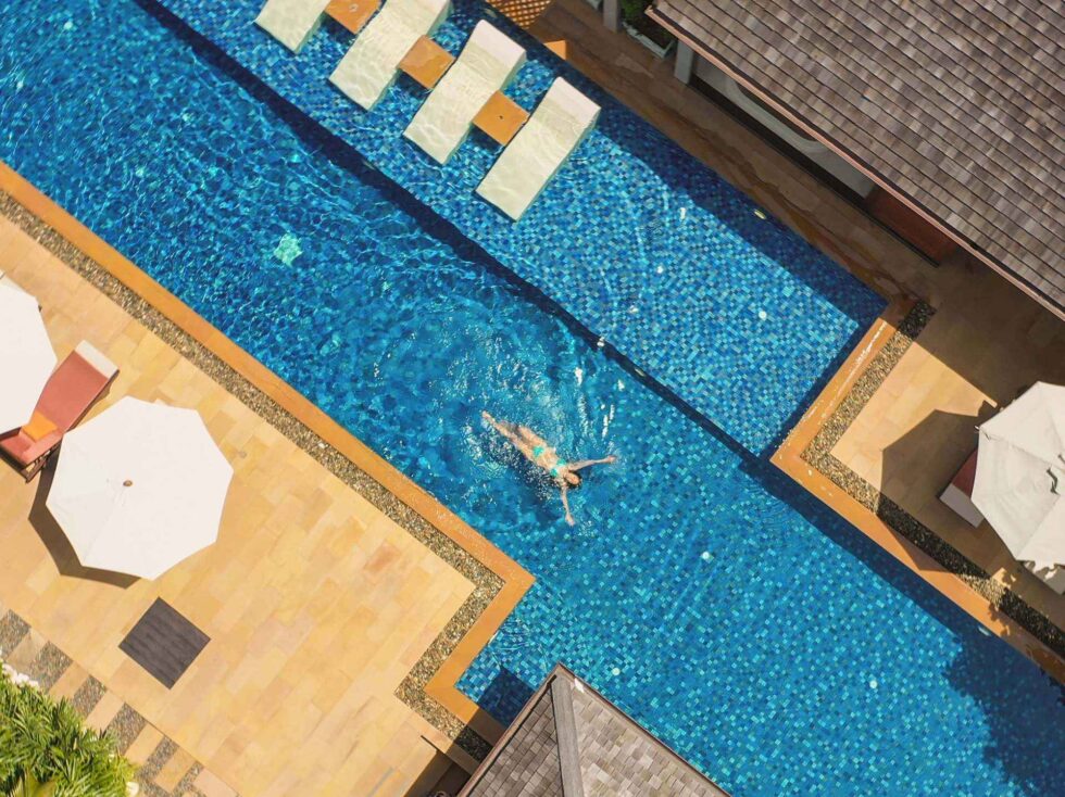 Taking a relaxing dip into the luxury villa's swimming pool